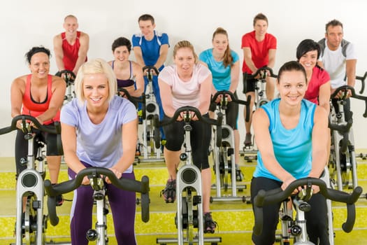 Spinning class group of young people at the gym
