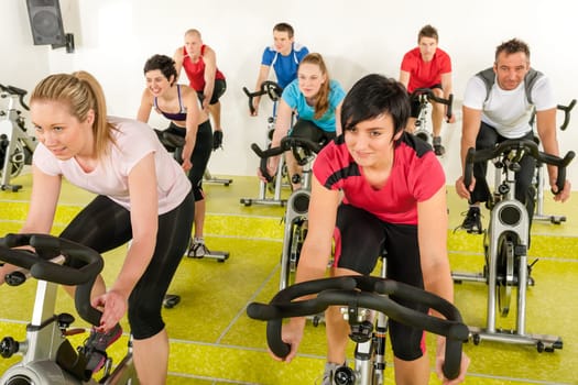 Spinning class people at the gym enjoy physical workout