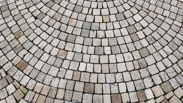 A patterned stone pavement featuring concentric circles in a plaza.
