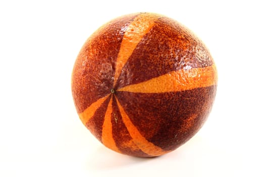 a fresh blood orange against a white background