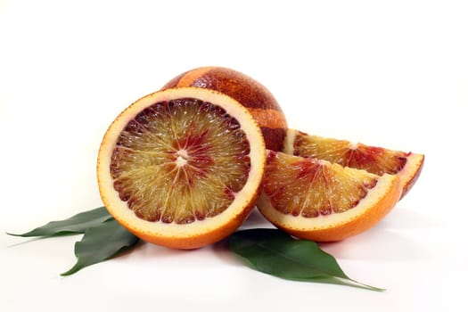 a fresh sliced blood orange against a white background