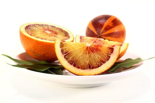 a fresh sliced blood orange against a white background
