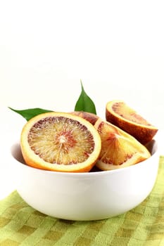 a fresh sliced blood orange against a white background