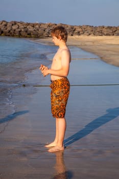 boy enjoys the beach in morning sun