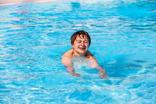 cute boy swimming in the pool