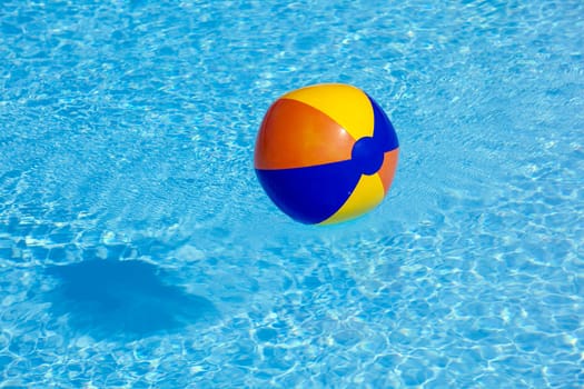 inflated plastic ball flying in the pool