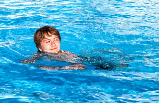 cute boy swimming in the pool