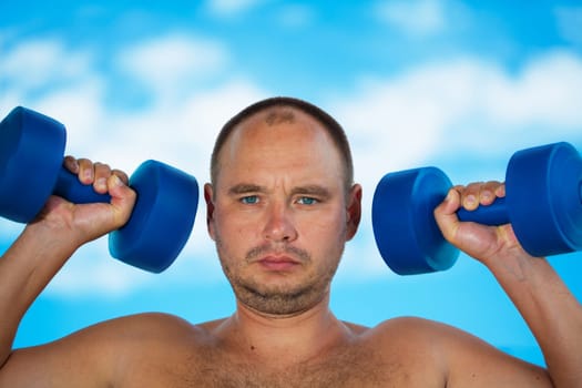 man with dumbbell weights outdoor