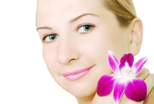 Close-up face of young woman with orchid on white background