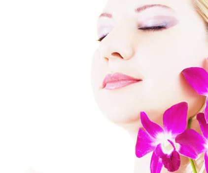 Face of young woman with closed eyes on white background