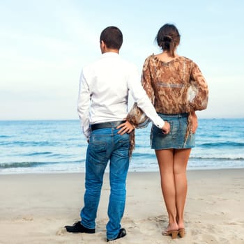Young couple. Sea on the background