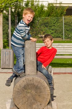 Children playing on a wooden train