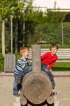 Children playing on a wooden train