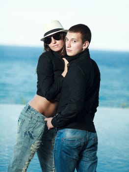 Young couple. Sea on the background