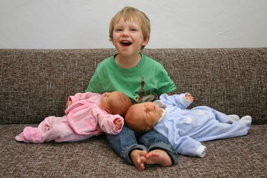 Big proud brother with his siblings on the sofa