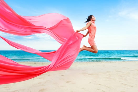 Woman jumping with red scarf