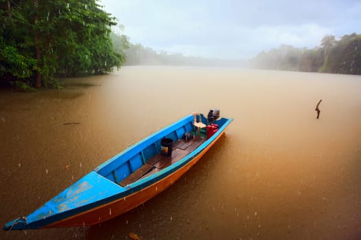 Fisherman boat in lake at rain time