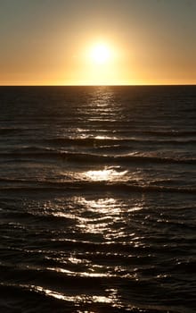 sun is setting over the sea at semaphore south australia