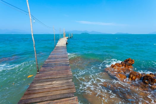 An empty dock extending out into the ocean