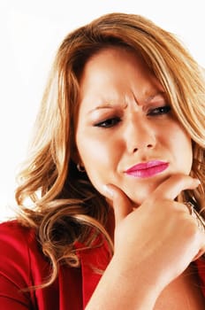A young blond woman holding her chin with one hand and looking very serious about a problem in closeup over white.