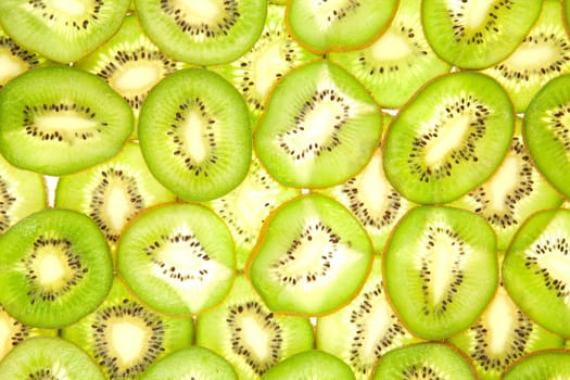 Background laid out in two layers from whole kiwi slices