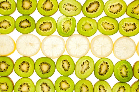 Background laid from whole kiwi and lemon slices