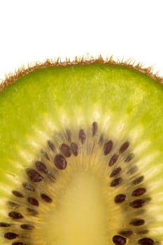 Macro shot of a kiwi slice against a white background