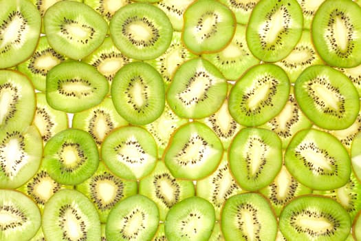 Background laid out in two layers from whole kiwi slices