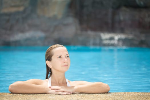 Young woman relaxing in swimming pool outdoor