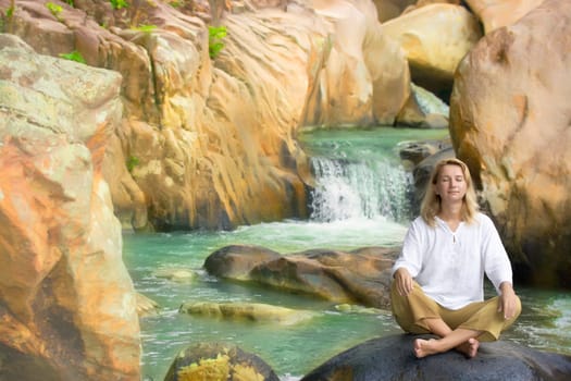 Young woman relaxing on waterfall background