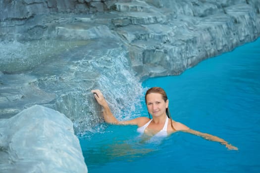 Young woman relaxing in swimming pool outdoor
