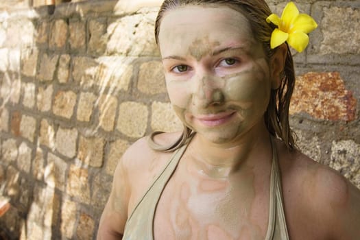 Young woman after mud bath outdoor.