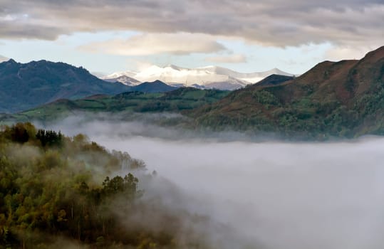 Sunrise with fog by peaks in Europe, asturias, Spain