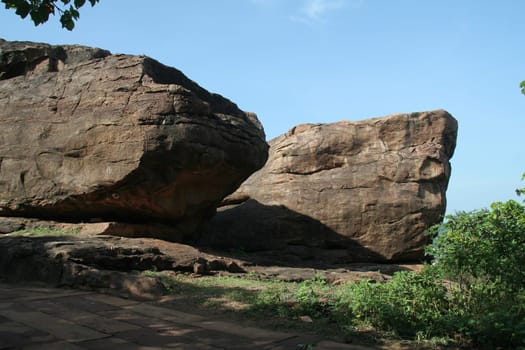 Smooth textured twin rocks in bright morning sunlight