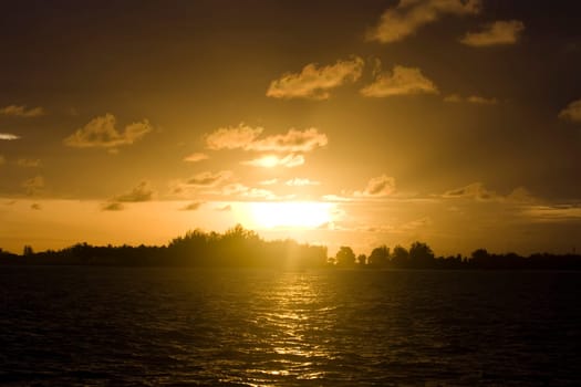Tropical sunset. Sun setting over the island in Indian ocean.