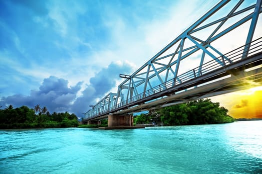 Railway bridge over the river at sunset time. Vietnam. Nha Trang