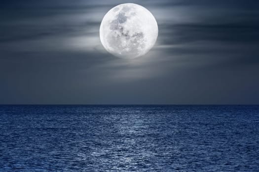 Water surface under moonlight at nighttime. Pacific Ocean