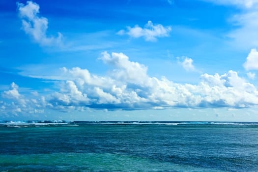 Tropical landscape. Infinity ocean and cloudy sky