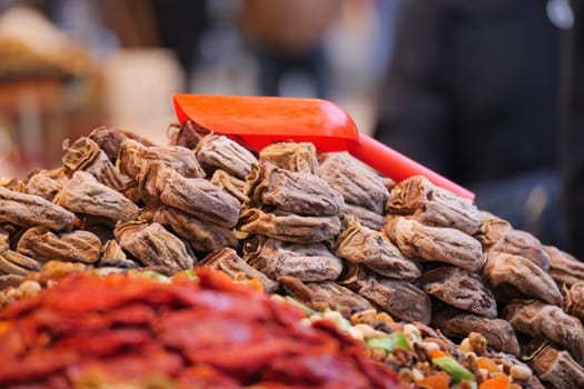 Colorful assortment of dried fruits and nuts attract market visitors.