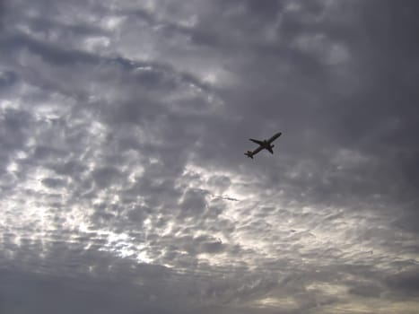 airplane and colorful sunset sky with clouds