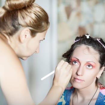 Woman in beauty salon reading for make-up