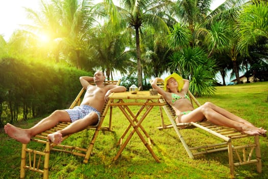 Young couple relaxing in tropical garden