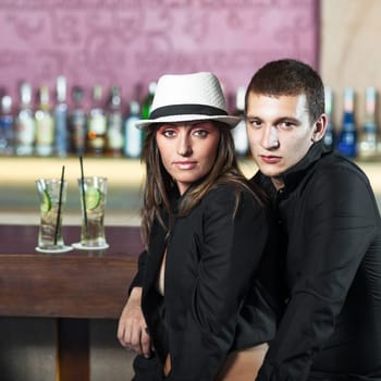 Fashion style photo of a couple in the bar
