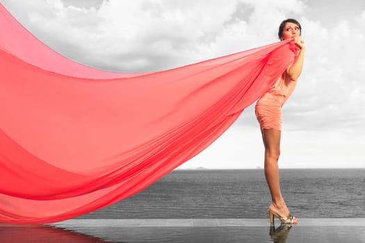 Woan with red scarf on water