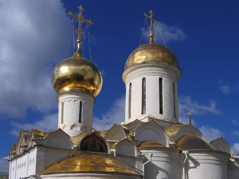 Domes of christian church on a background of the cloudy sky