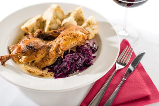 Roasted duck with red cabbage and dumpling isolated on white