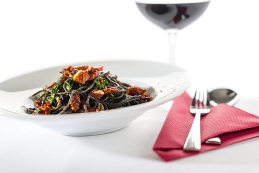 Italian style spaghetti with dried tomatoes, garlic on white background