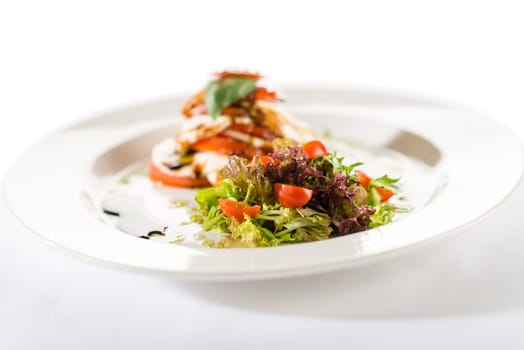 Fresh and delicious Caprese salad with tomatoes on white background