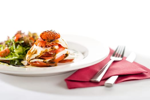 Fresh and delicious Caprese salad with tomatoes isolated on white