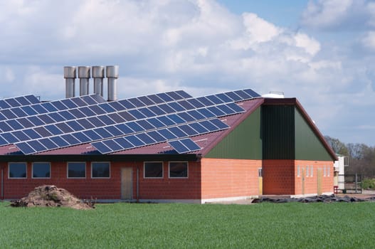barn with its roof full with solar panels